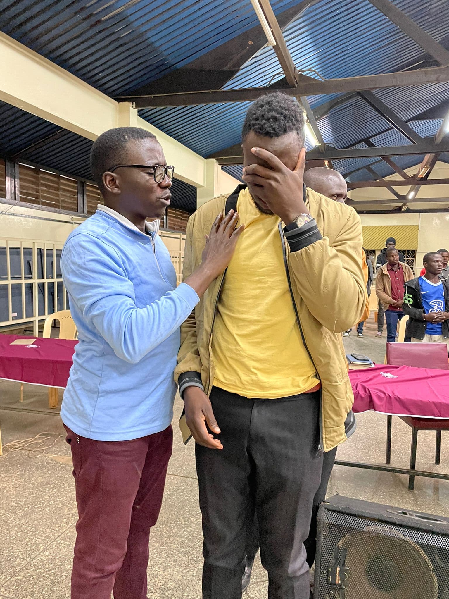 Pastor praying with a brother