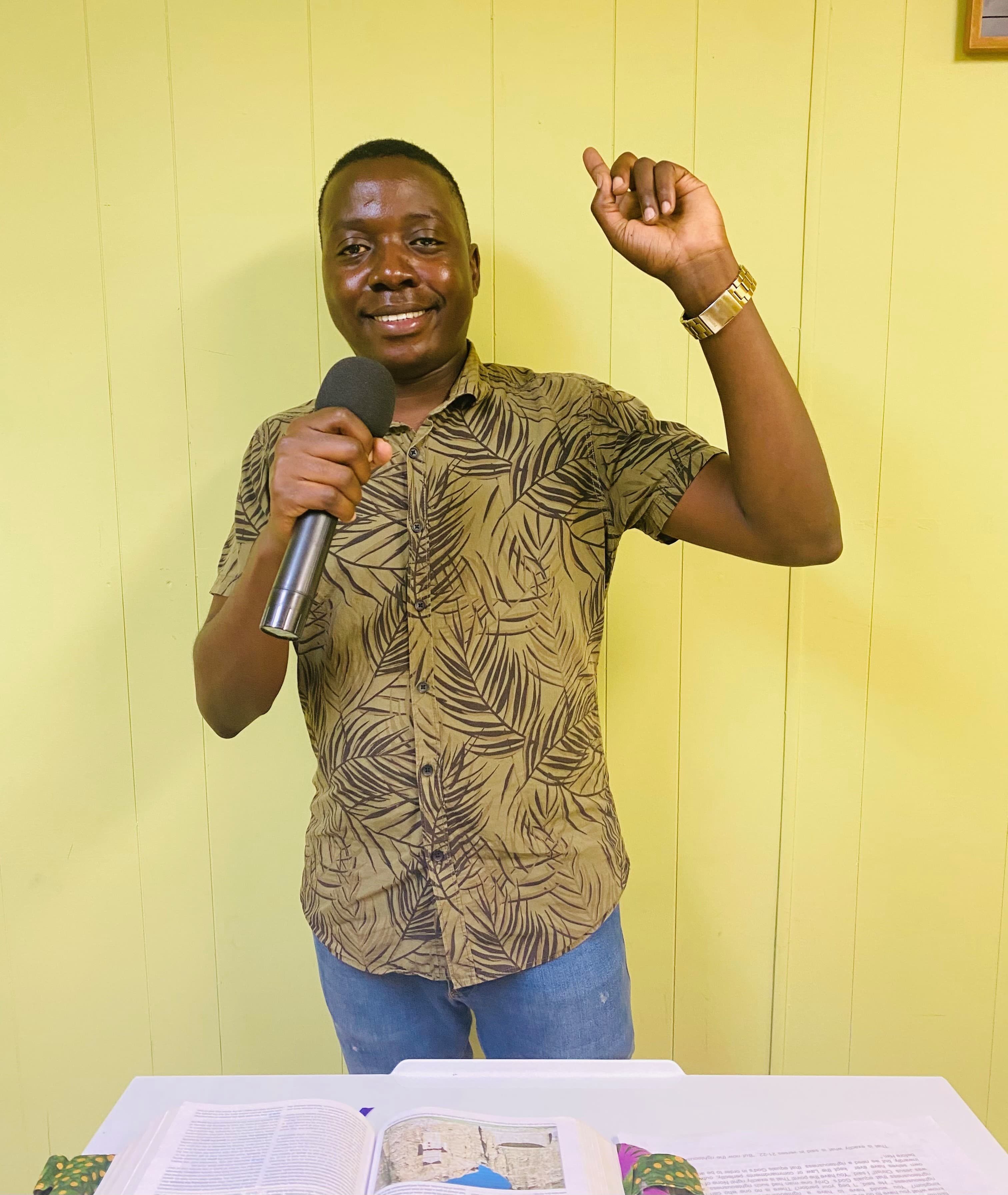 Pastor with microphone and open Bible
