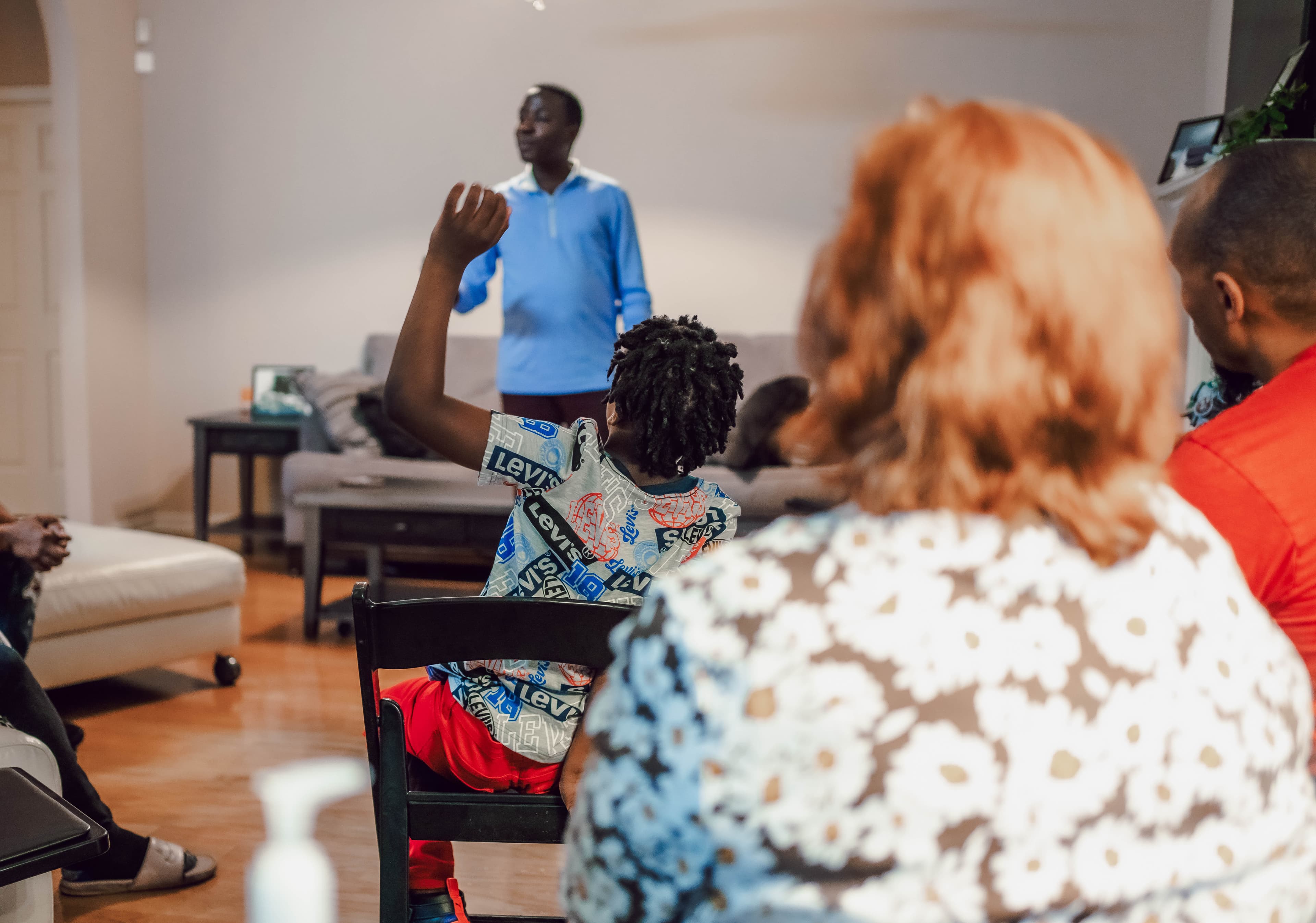 A young hand raised during teaching
